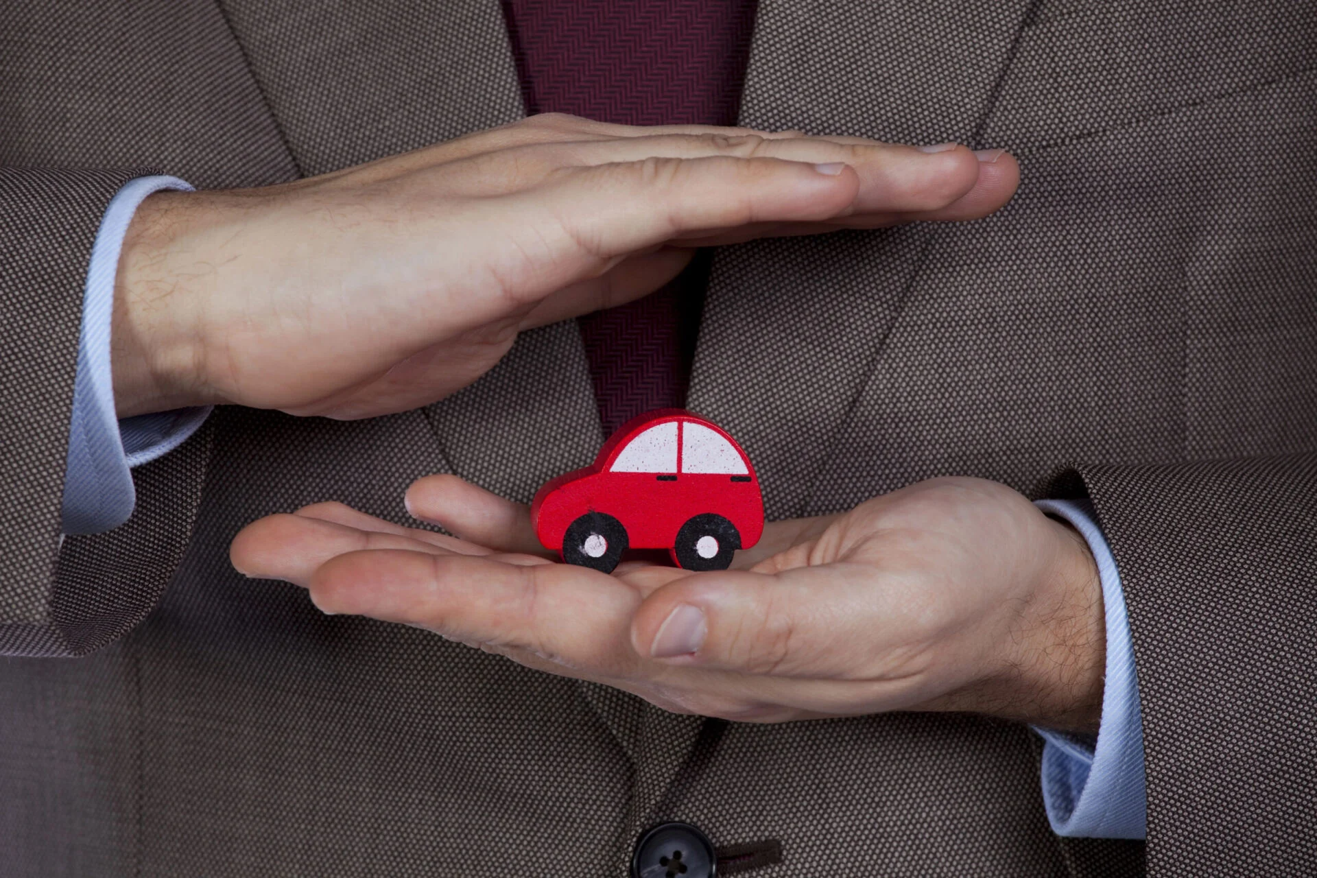 Man holding small toy car