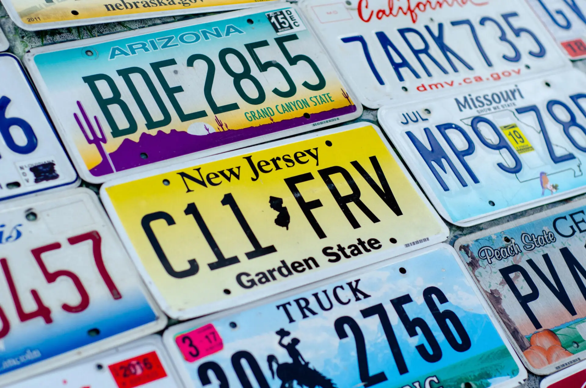 License plates from a variety of states all laying next to each other