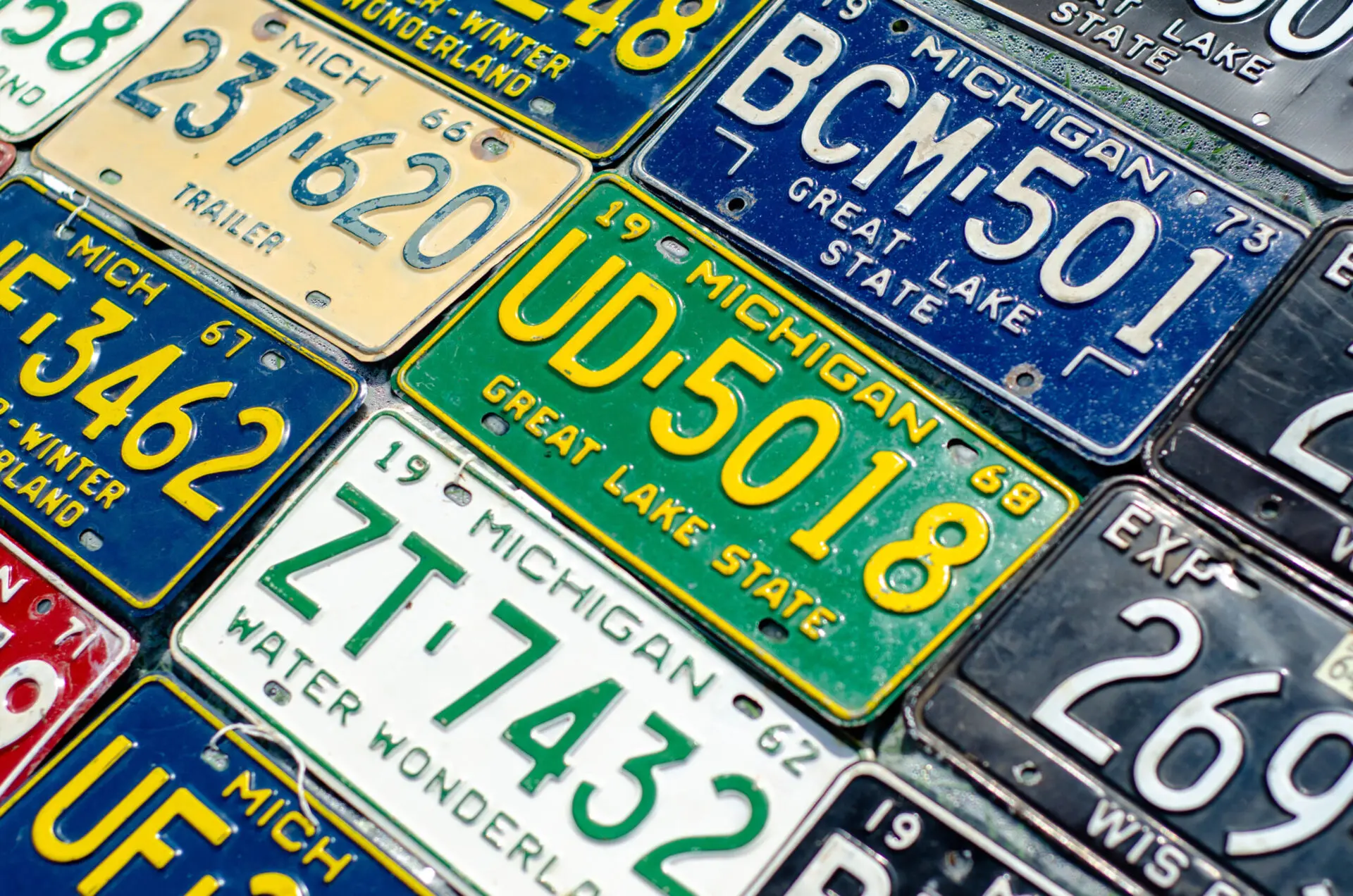 Several state of Michigan license plates all sitting next to each other
