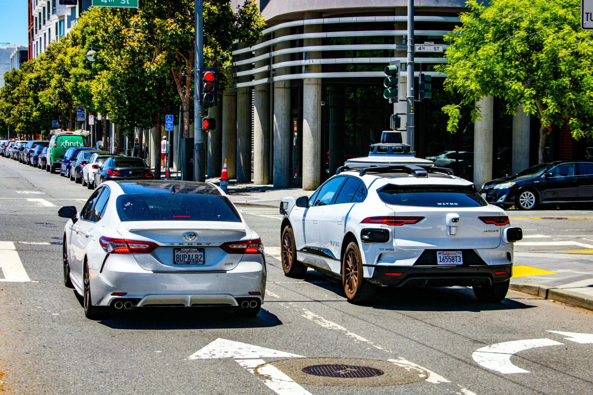 Two cars waiting at a stop light in downtown