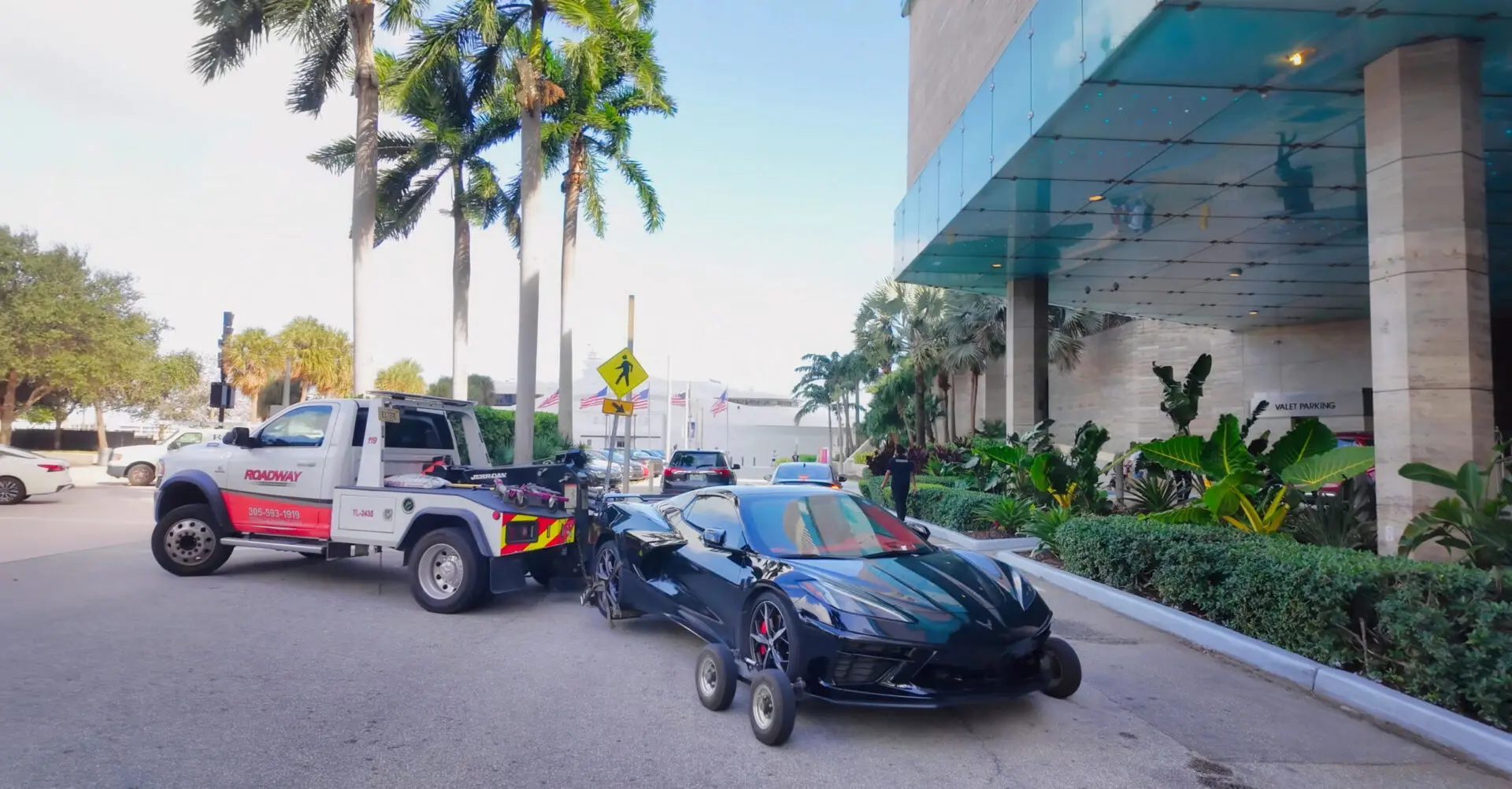 Black sports car getting towed away